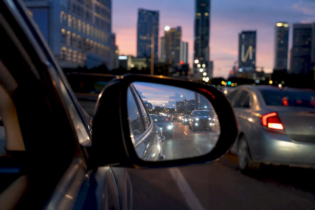 Car side mirror showing traffic congestion