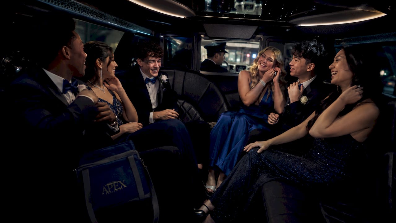 Prom teens buckling seatbelts inside limo
