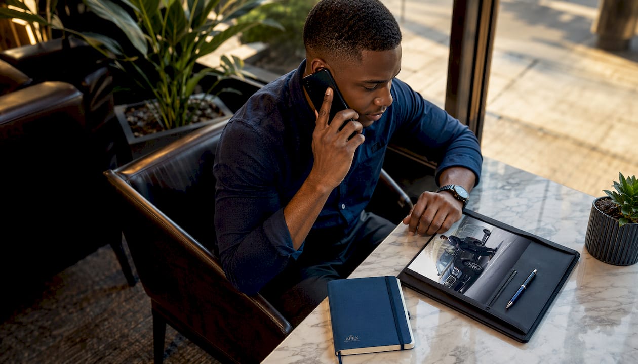 Man booking limousine service by phone