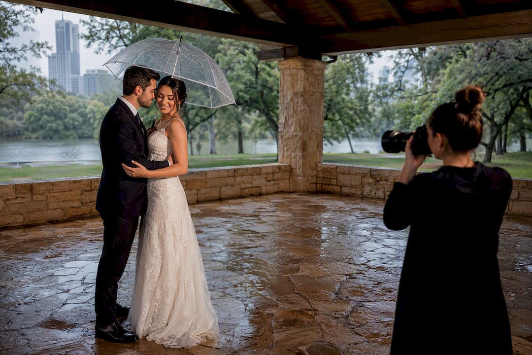 Newlywed couple taking portraits under pavilion